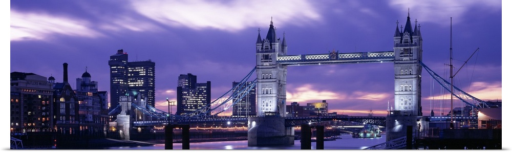 Spectacular panoramic view of the Tower Bridge, the River Thames and the skyline of London at night.