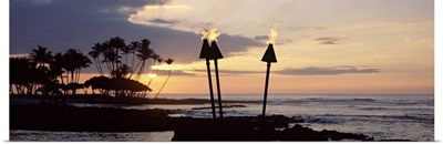 Flaming torches on the beach at sunset, Fairmont Orchid, Hawaii
