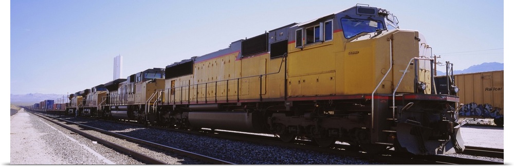 Freight train on railroad tracks, California