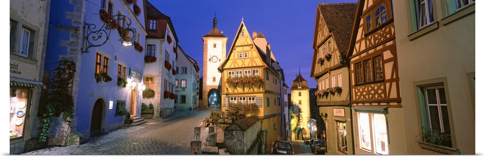 Panoramic photograph looking down two brick roadways between rows of  German buildings, in Rothenburg ob der Tauber, Germany.