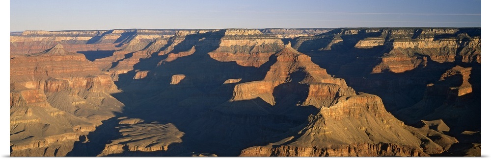 Panoramic photograph of the large rock formations of the Grand Canyon in the golden sunlight, in Arizona.