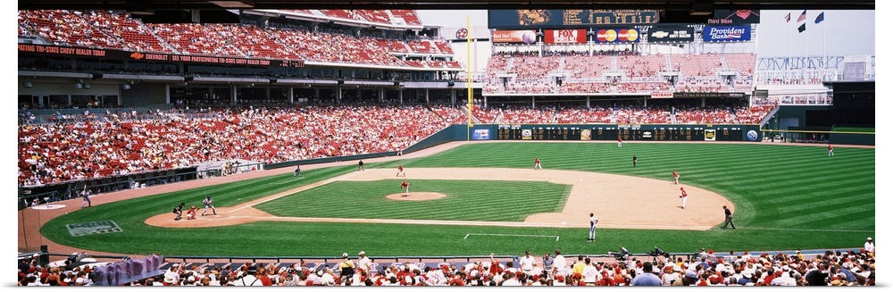 Long horizontal image of a baseball game being played as spectators watch in Ohio.