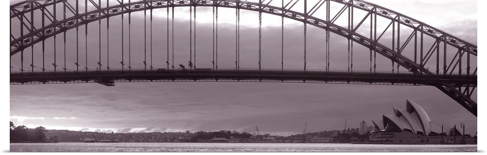 Panoramic photo on canvas of a long bridge over water in Sydney with the Opera House in the lower right.