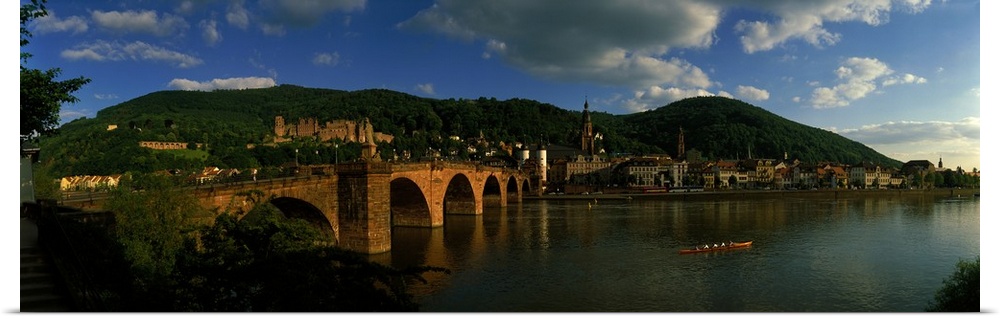 Panoramic photo on canvas of an old stone bridge entering a German city along the waterfront.
