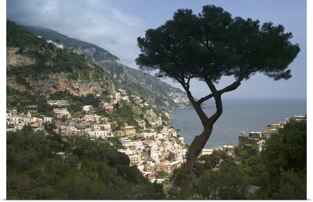 Photo taken high up in the cliffs of the Amalfi Coast looking down at the light colored buildings of the town that overloo...