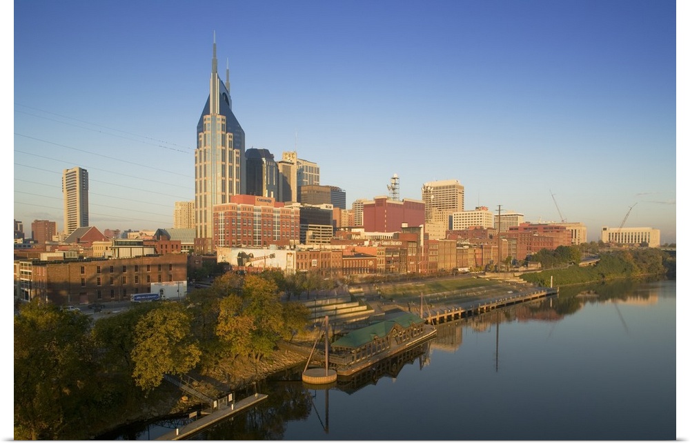 This oversize piece is a photograph taken of the skyline in Nashville that sits along a body of water.