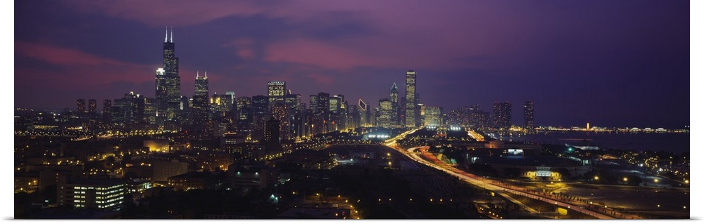 Panoramic photograph from above of the lights of the Chicago city skyline at night.