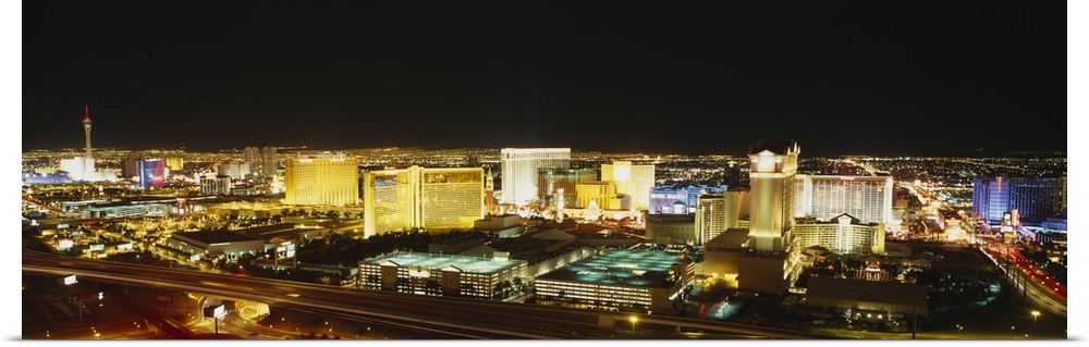 Panoramic, high angle photograph of brightly lit buildings of the Las Vegas skyline, in Nevada.