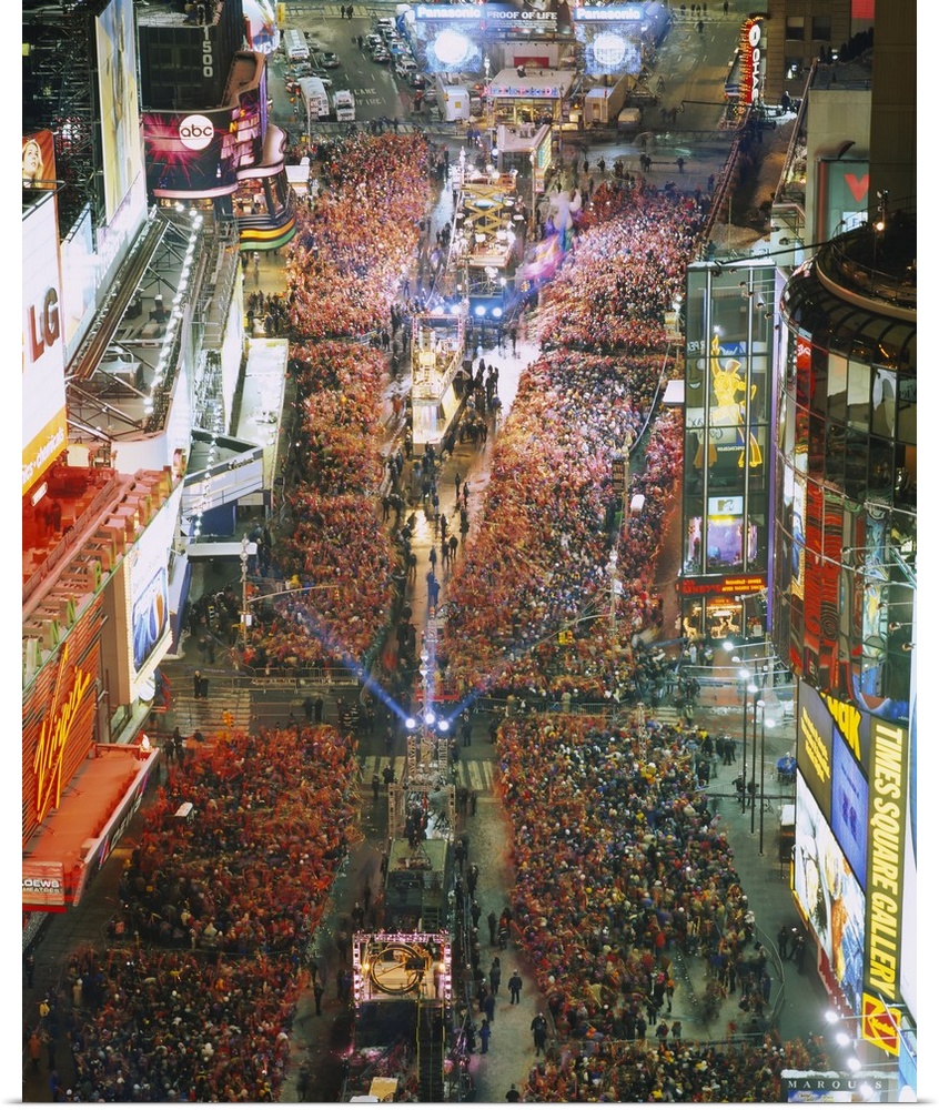 Photograph of iconic city block in the ""Big Apple"" and night that is crowded with people waiting to bring in the new year.