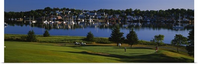 High angle view of four people playing golf at a golf course,Lunenburg Harbor, Lunenburg, Nova Scotia, Canada