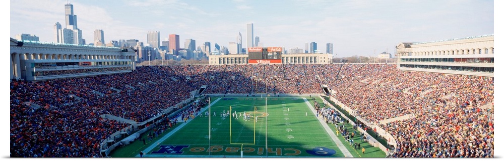 Panoramic photograph of a football stadium with the stands packed with fans ready to watch the Chicago Bears game.