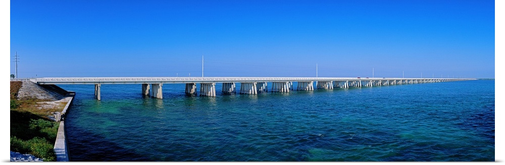 Big panoramic photo print of a long bridge going over the ocean.