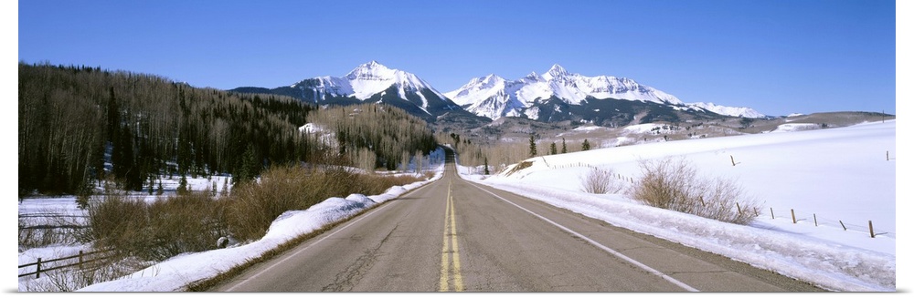 Highway in front of snowcapped mountains, Telluride, Colorado