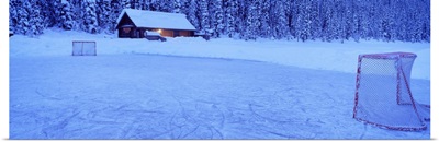 Hockey net on a snowcapped landscape, Lake Louise, Alberta, Canada