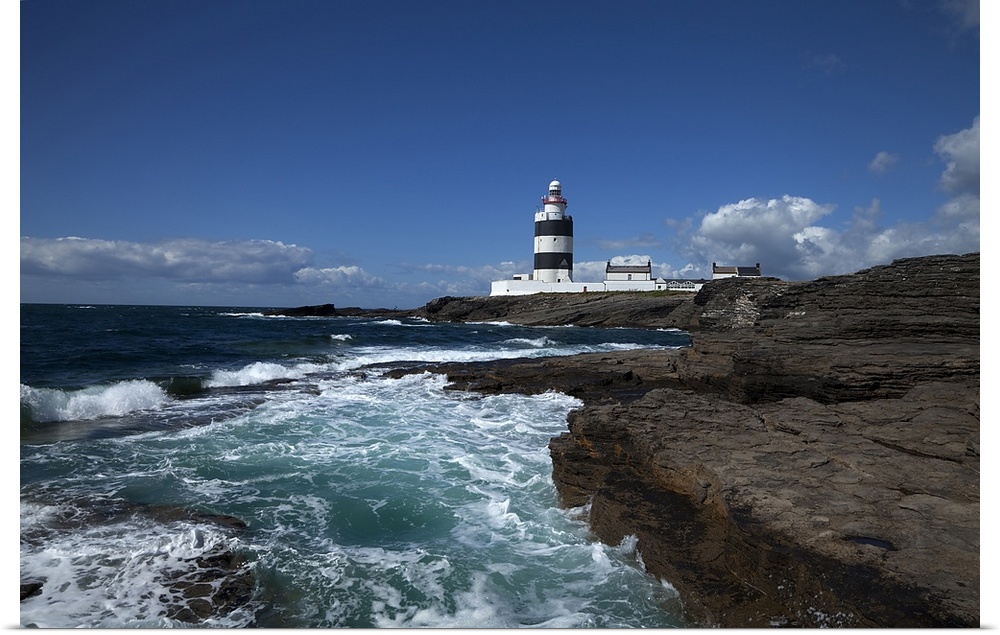 Landscape photograph on a giant canvas of waves crashing into the rocky shoreline in County Wexford, Ireland.  Hook Head L...