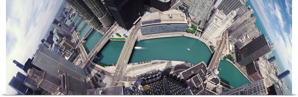 A wide angle photograph taken from an aerial view of the Chicago skyline with the river running through it.