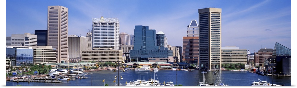 Panoramic image of the harbor area of downtown Baltimore, Maryland with sailboats and yachts parked in the marina.