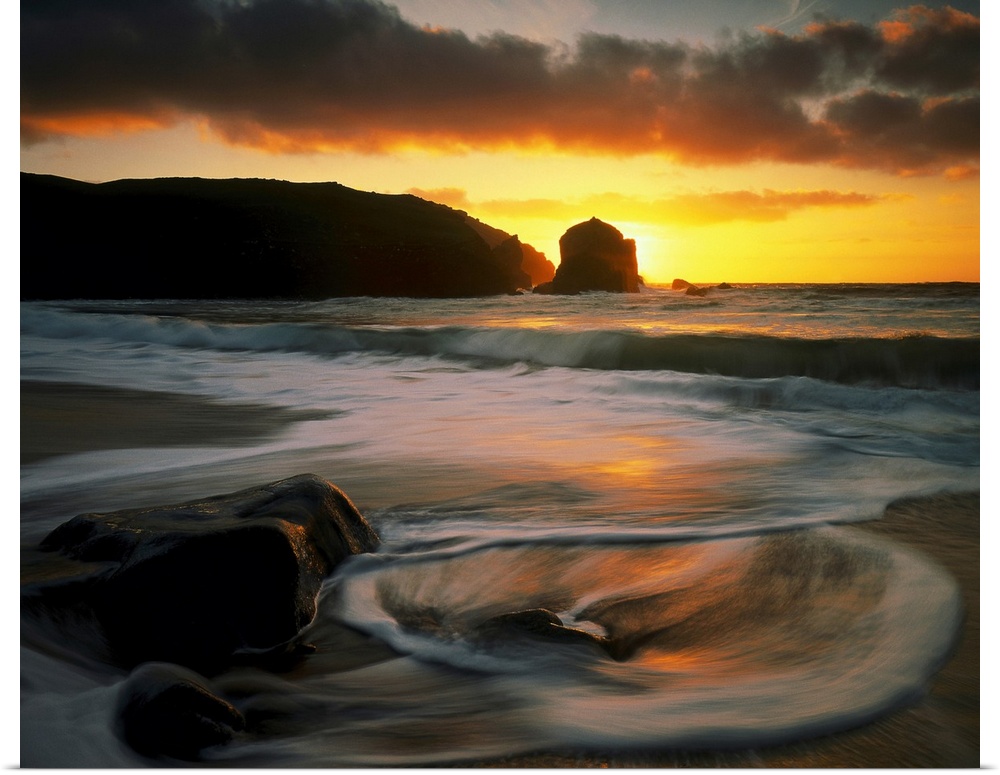 Beautiful time lapsed photography wall art of waves on the beach at sunset.