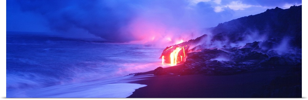 This panoramic photograph was taken at twilight and focuses on the glowing magma as it meets the sea and the air fills wit...