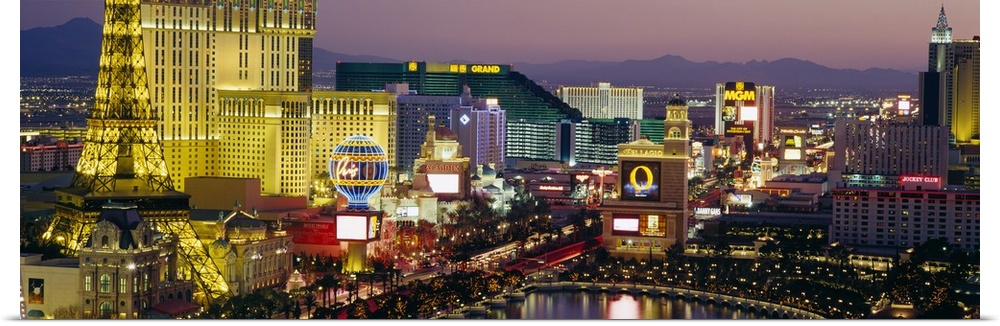 Panoramic photograph taken of the Las Vegas skyline at night with the bright lights of the buildings shown.