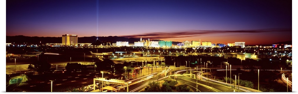 Las Vegas buildings illuminated at sunset.