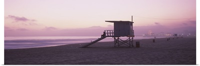 Lifeguard hut on Santa Monica Beach, Santa Monica Pier in distance, Santa Monica, California