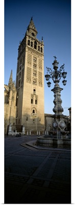 Low angle view of a lamppost in front a church, La Giralda, Seville Cathedral, Seville, Seville Province, Andalusia, Spain