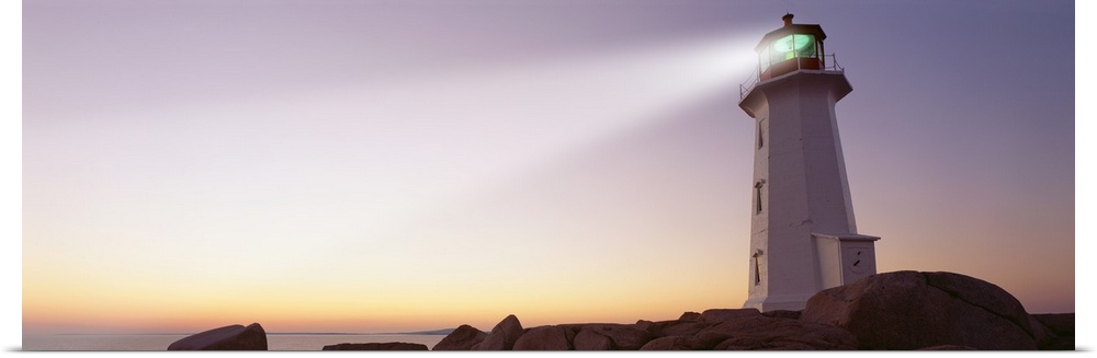 This panoramic piece is a picture taken of a lighthouse that sits on a rocky cove and shines out over the ocean.