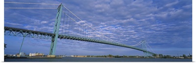 Low angle view of a suspension bridge over the river, Ambassador Bridge, Detroit River, Detroit, Michigan