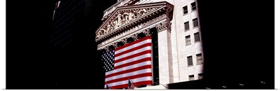 Low angle view of an American flag on a financial building, New York Stock Exchange, Wall Street, Manhattan, New York City, New York State