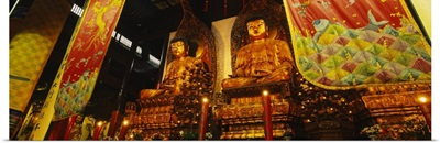 Low angle view of golden Buddha statues, Heavenly King Hall, Jade Buddha Temple, Shanghai, China