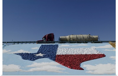 Low angle view of truck and map of Texas on the slope beside a highway, Pecos, Texas
