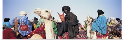 Low angle view of tuaregs riding on camels, Mali