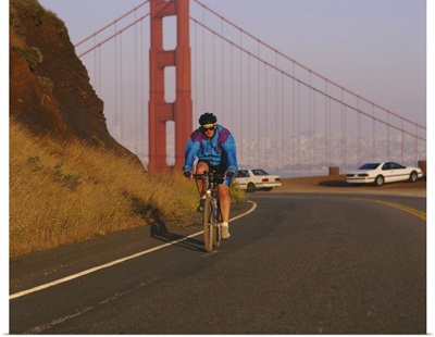 Mid adult man cycling, Golden Gate Bridge, San Francisco, California