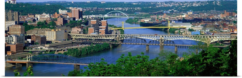 Big, horizontal, high angle photograph of numerous bridges crossing the Monongahela River, surrounded by the cityscape of ...