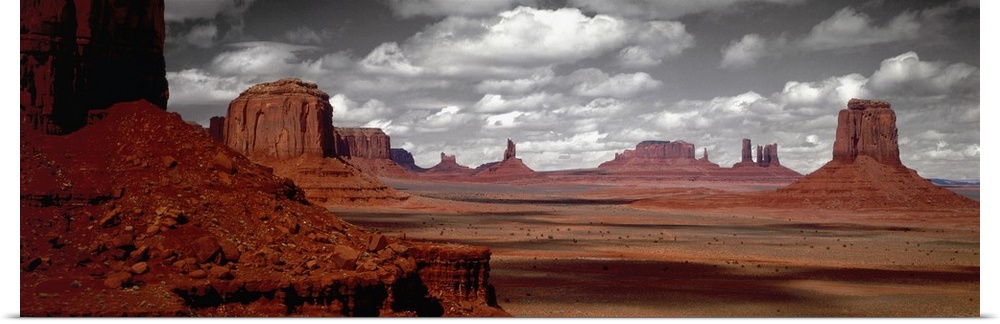 Selective color photograph of the Arizona desert landscape. The rocky landscape remains in color under a black and white sky.