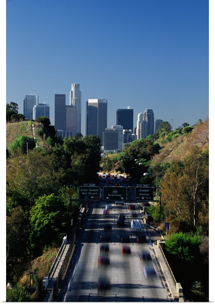 This large vertical piece is a photograph taken of the Pasadena freeway during a morning commute. The city is pictured in ...