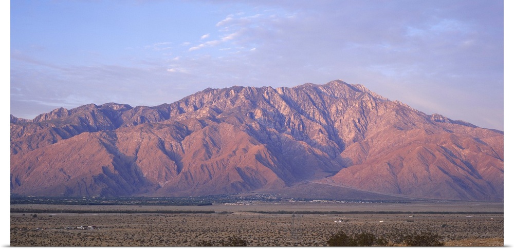 Wide angle picture of San Jacinto Peak in California. The sun is setting out of view and shining onto the mountain range.