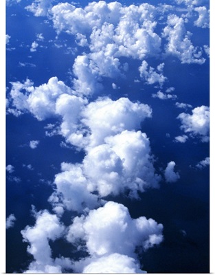 Multiple white clouds, blue sky.