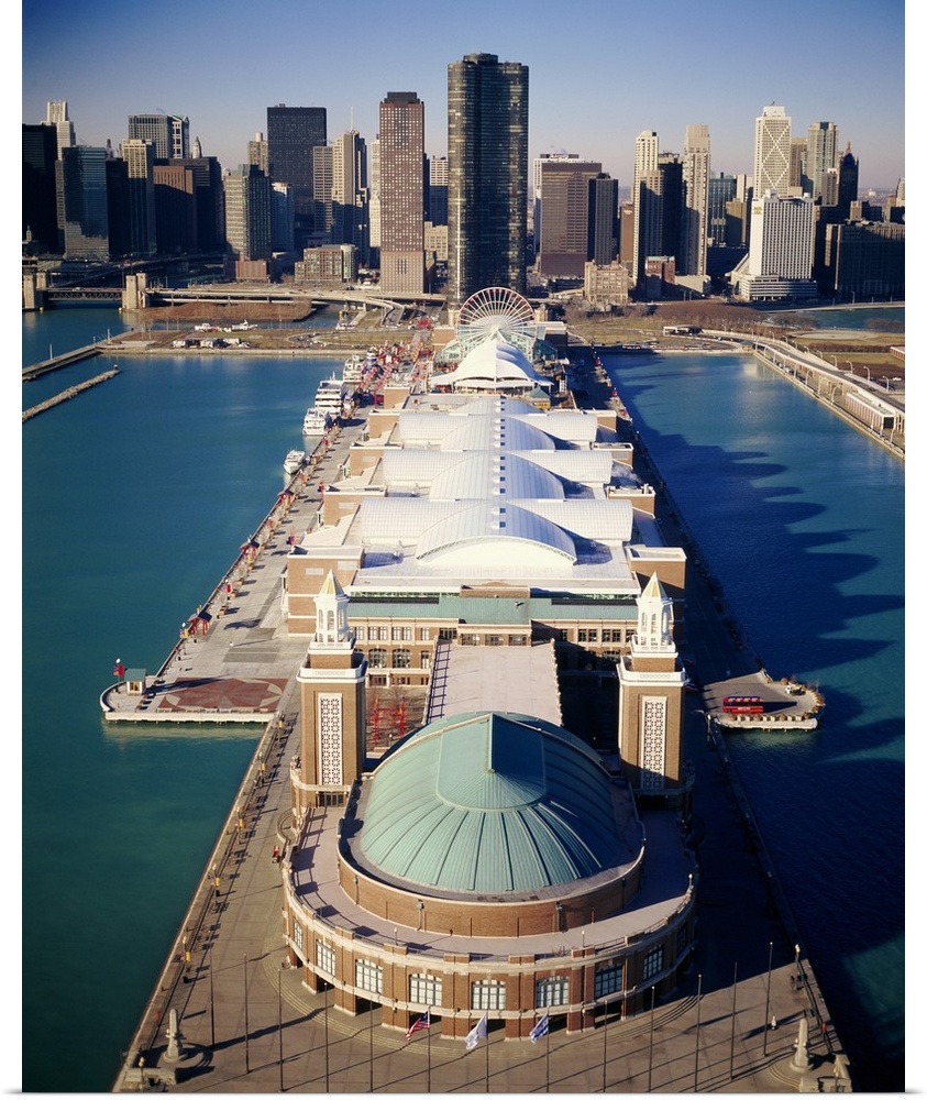 A vertical photograph of a pier that juts out into Lake Michigan with a large pavilion built on top of it.