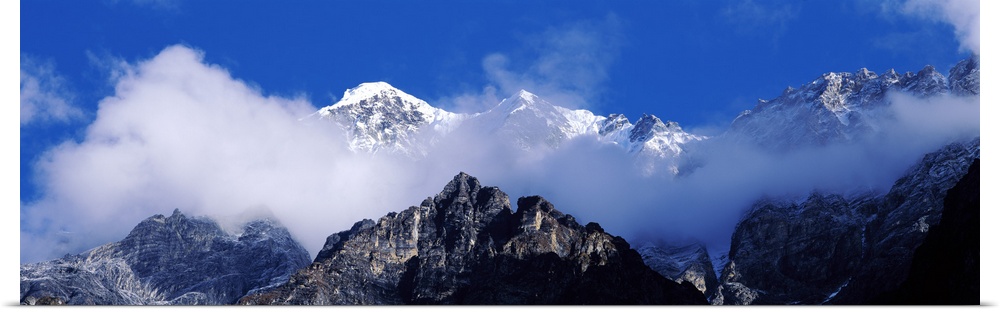 Nepal, Manaslu Trek, Low angle view of clouds around mountain peaks