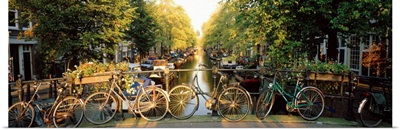 Netherlands, Amsterdam, bicycles on bridge over canal