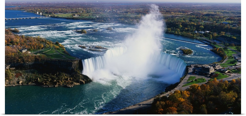 Aerial photo of Niagara Falls lined by Canada on one side and New York on the other.
