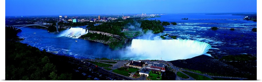 Aerial panoramic looking down at Niagra Falls and all the water spraying up in to the air with Ontario Canada in the backg...