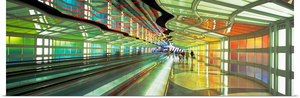 Panoramic photograph of moving sidewalk in airport terminal with people in the distance.