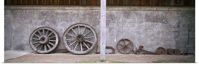 Old wagon wheels along a wall, Larnach Castle, Dunedin, Otago Region, South Island, New Zealand