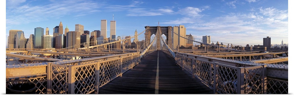 Panoramic view from the Brooklyn Bridge of walk into Manhattan with skyscrapers in the background.