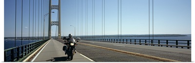 Person riding a motorcycle on a bridge Mackinac Bridge Lake Michigan Mackinaw City Michigan