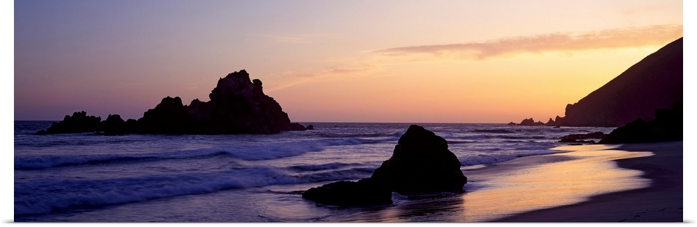 Oversized, horizontal, panoramic photograph of the shoreline at Pfeiffer Beach in Big Sur, California.  Taken at sunset, w...