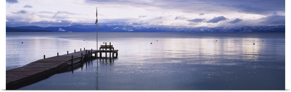 Large dock on Lake Tahoe in California with mountains in the background.